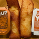 Wendy's and Burger King syrup containers sit next to a French toast stick from each restaurant.